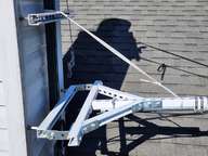 When it's laid down, I support the pole with 2500lb test mule line lanyards.  I'm monitoring how it handles UV exposure, but so far it's good.