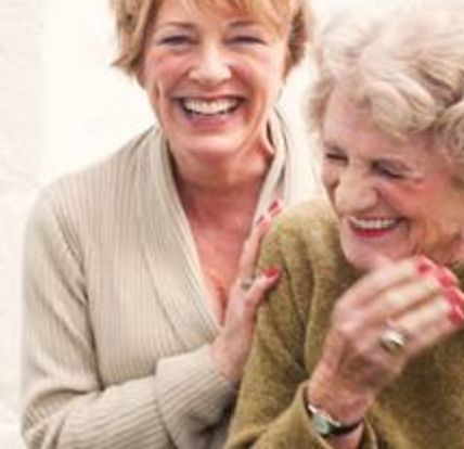 Image: Two people laughing together.