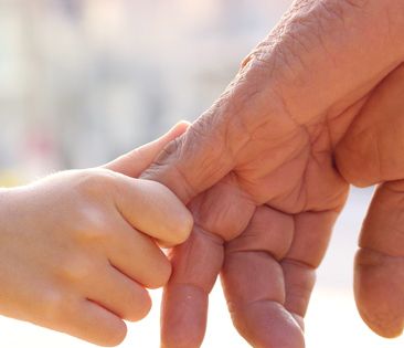 Image: Young hand grasping old hand.