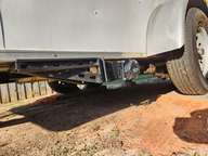 The port Road Hazard Deflector Shield, mounted solidly to the frame.