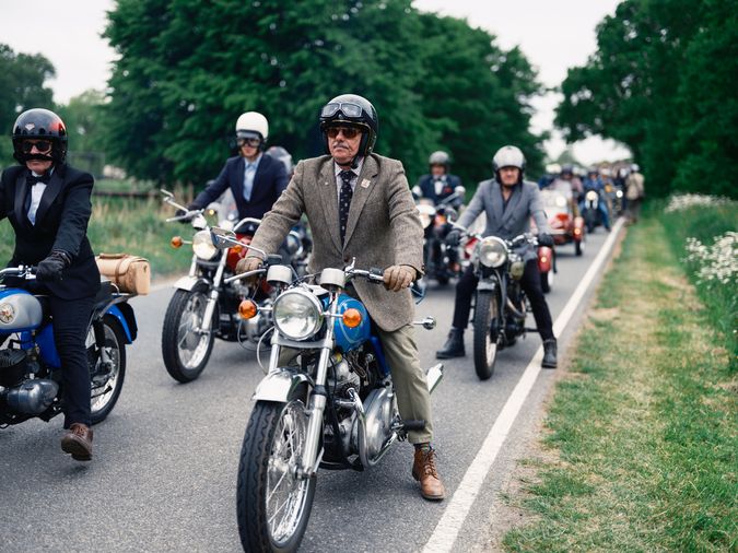 A group of distinquished gentlemen on motorcycles.