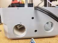 A look from the bottom.  Left is air tunnel opening. Holes for power switch and reset switch. Right is vent to electronics.
