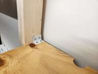 Top of the shelf: the bracket goes as far back as possible.  The shelf is cantilevered between brackets.