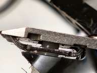 Also notice the curved metal to the right is pushed down against the edge of its slot. These are clues.