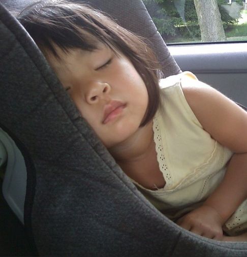 This is NEVER going to end. Image: A child that has falled asleep in the back seat.